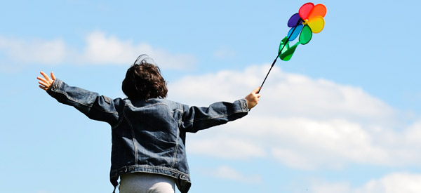 Boy with windmill looking at the sky